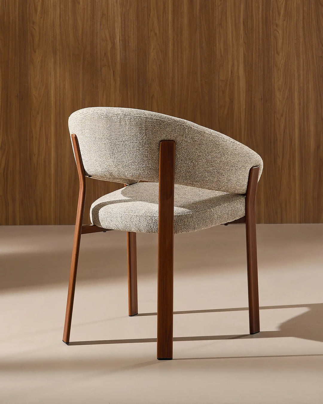 Side view of Bramley warm taupe and walnut rustic dining chair showing curved silhouette and armrests