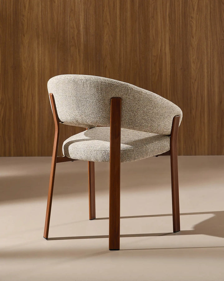 Side view of Bramley warm taupe and walnut rustic dining chair showing curved silhouette and armrests