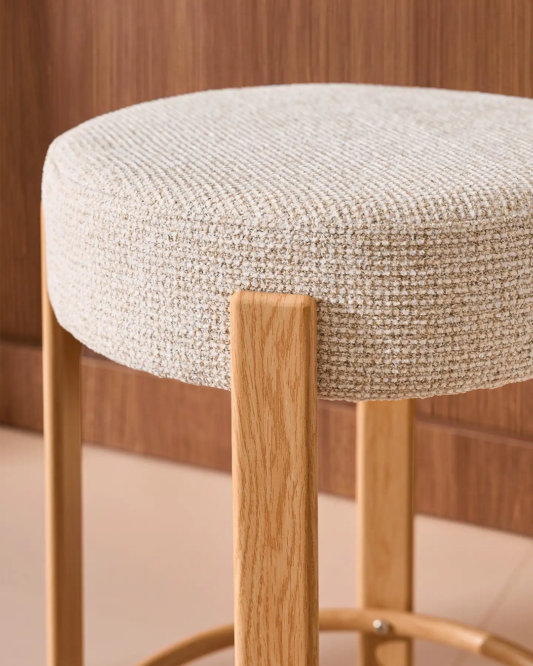 Close-up of the Bramley bar stool cream chenille upholstery, showing the soft textured weave and gently rounded padded seat
