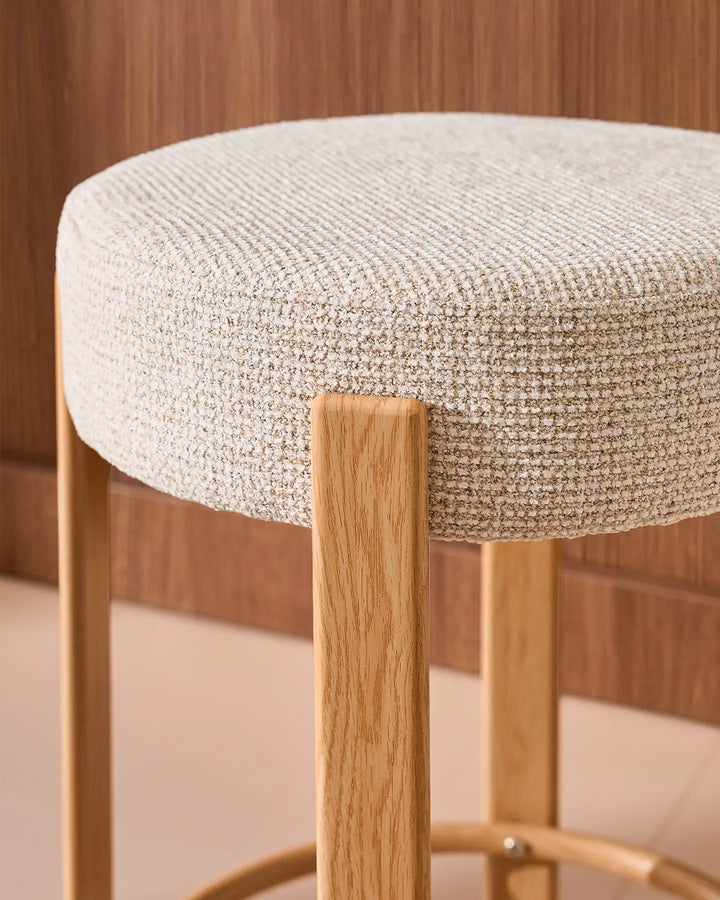 Close-up of the Bramley bar stool cream chenille upholstery, showing the soft textured weave and gently rounded padded seat