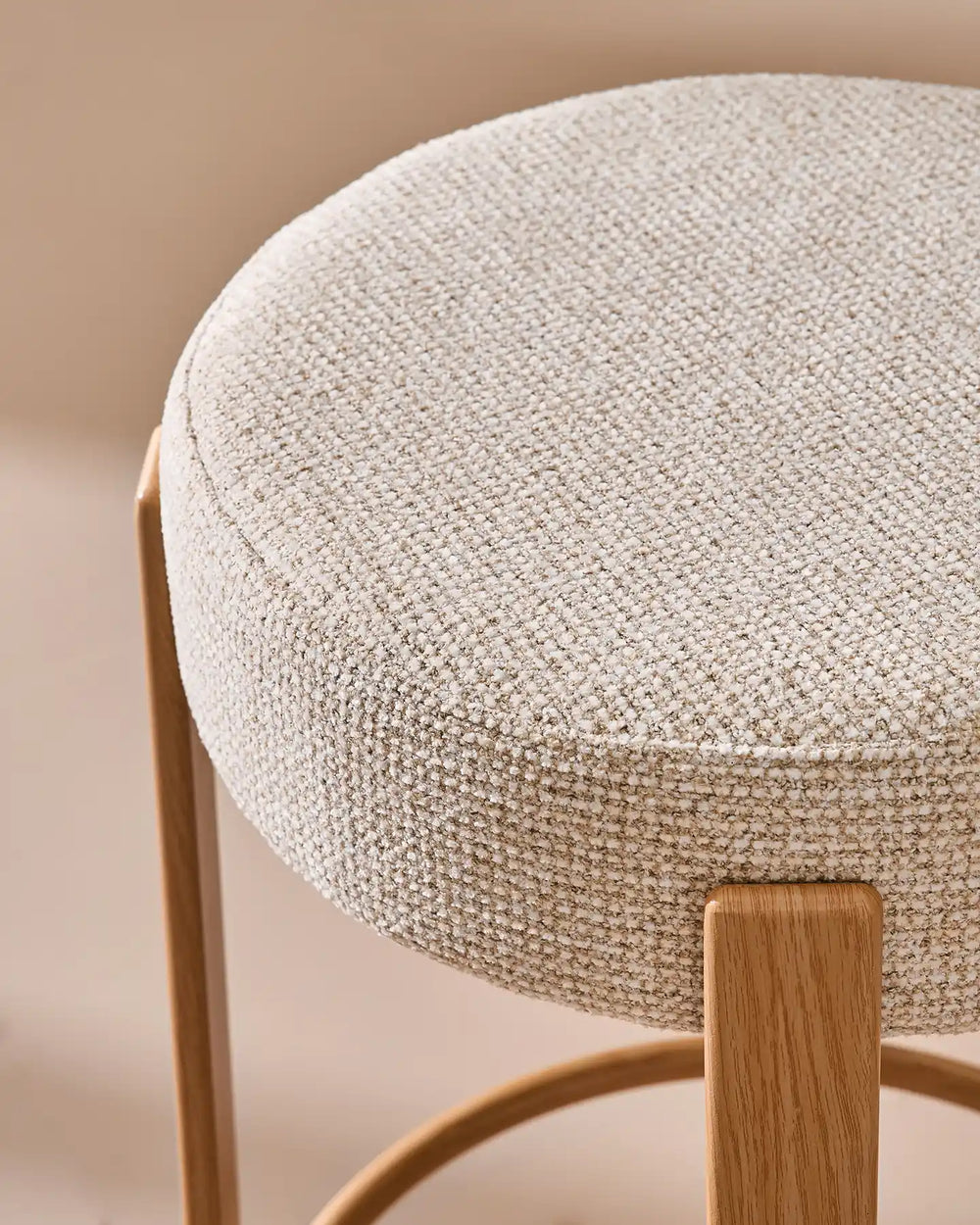 Close-up of the Bramley cream chenille bar stool seat, highlighting the textured fabric, soft padding and rounded edge