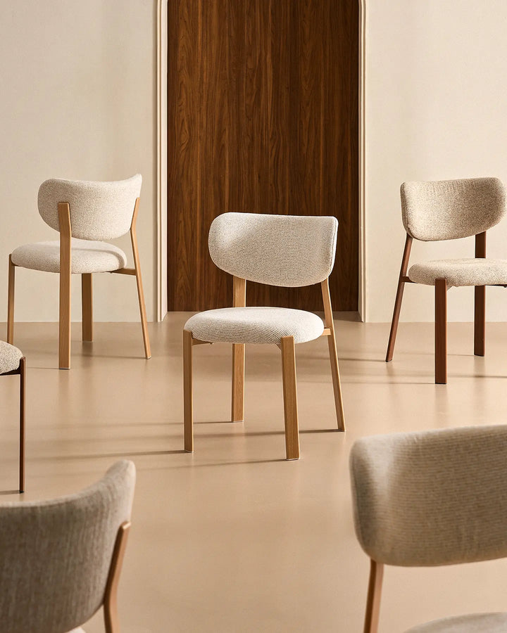 A selection of Bramley dining chairs with wood-effect legs styled in a neutral interior