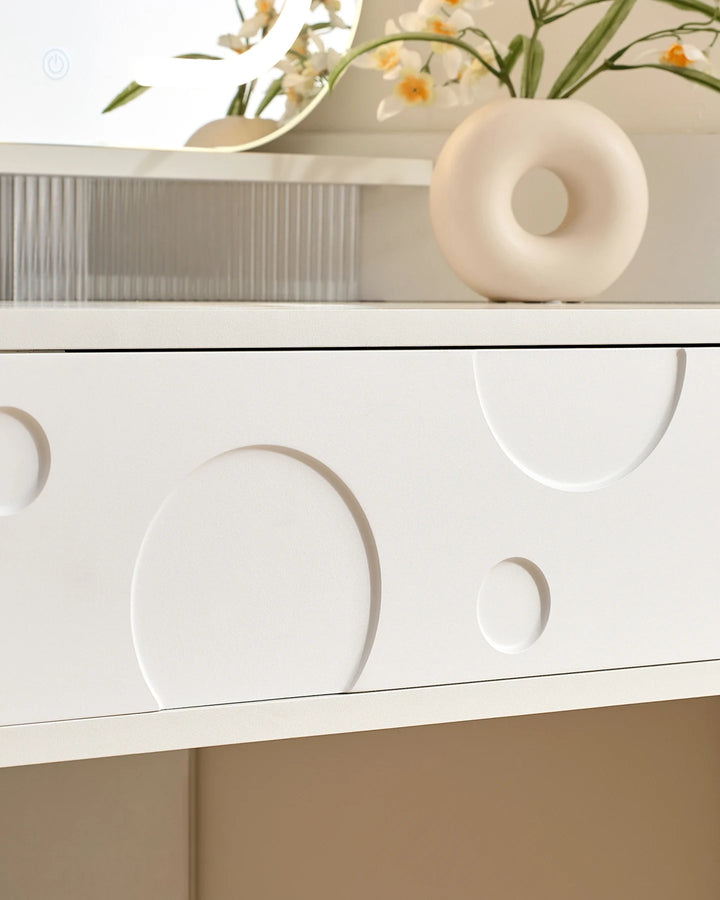 Close-up of the cheese-inspired drawer front on a white corner dressing table
