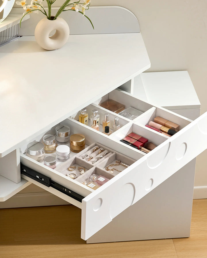 Close-up of the drawer compartments in a white corner dressing table