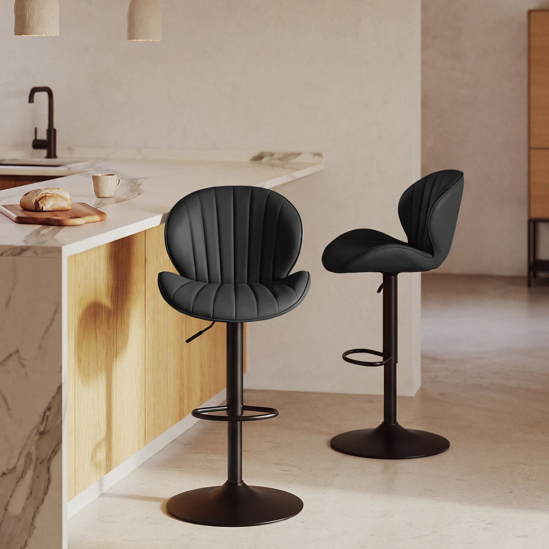 2 bar stools with shell back and ajustable height, beside a kitchen island