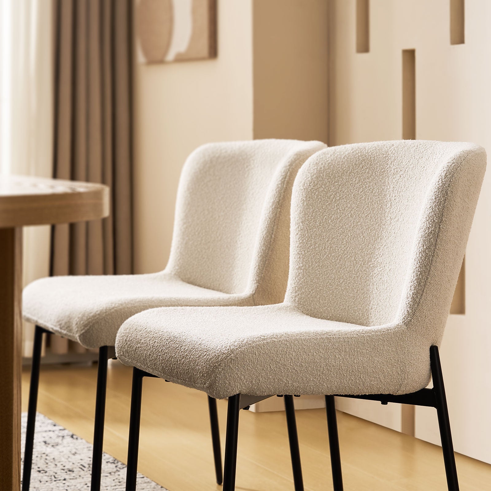 Close-up of the boucle fabric detail on the backrest of the cream Celeste Dining Chair.