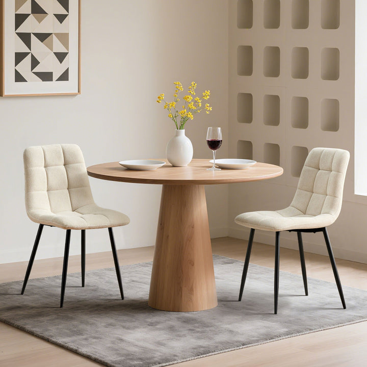 Set of 2 cream Christie Fabric Dining Chairs beside a dining table, adding a soft touch of colour to the dining room.