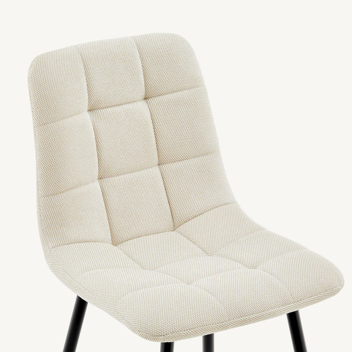 Close-up of the linen woven fabric detail on the backrest of the cream Christie Fabric Dining Chair.