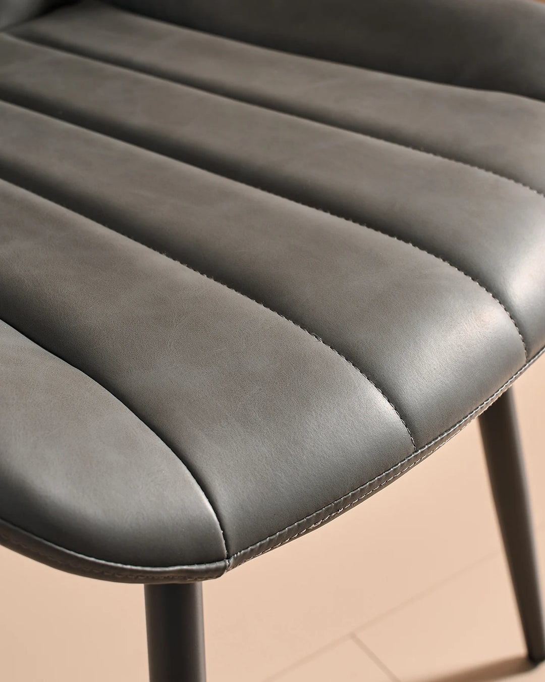Macro detail of the premium grey faux leather material with channel tufted padding, showing a soft, hard-wearing and wipe-clean surface.
