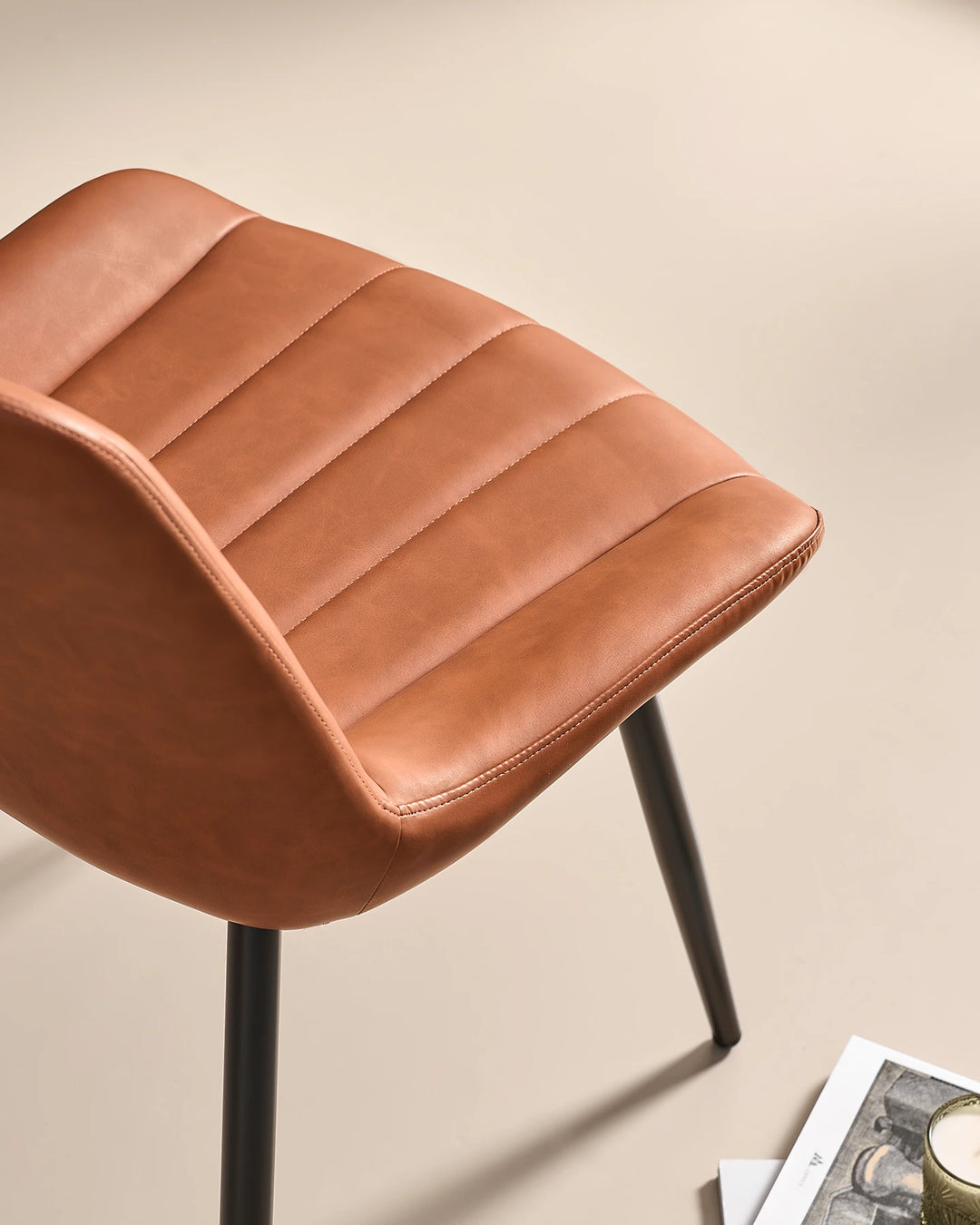 Macro detail of the premium tan brown faux leather material with channel tufted padding, showing a soft, hard-wearing and wipe-clean surface.