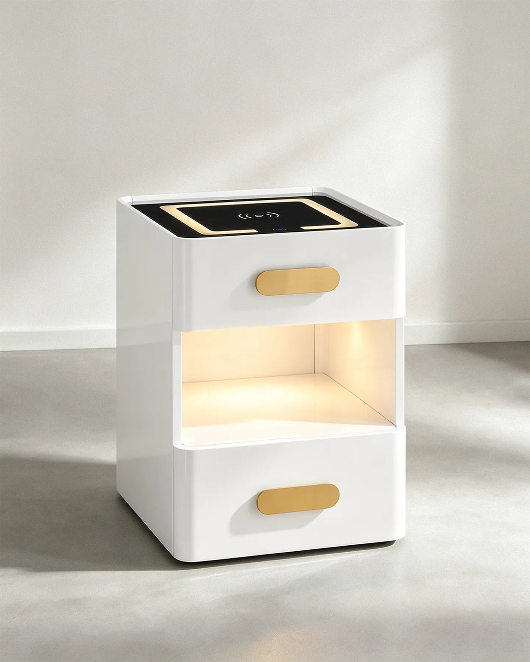 Angled view of the Clara LED bedside table highlighting the sleek white finish and gold drawer pulls.