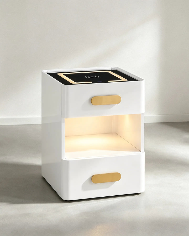 Angled view of the Clara LED bedside table highlighting the sleek white finish and gold drawer pulls.