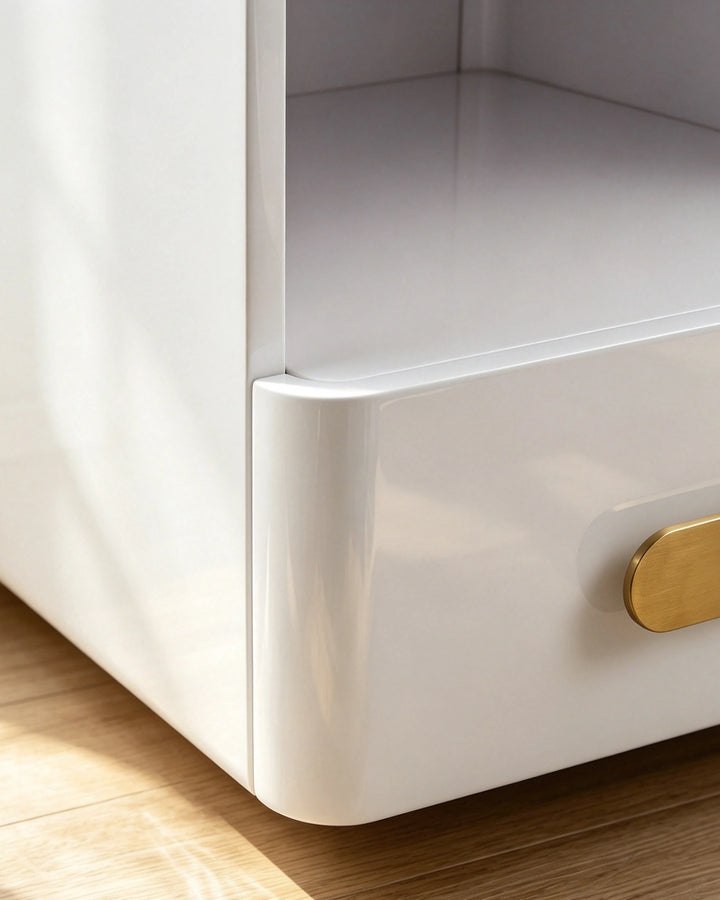 Close-up of the smooth white lacquer finish and rounded corner design of the Clara nightstand base.