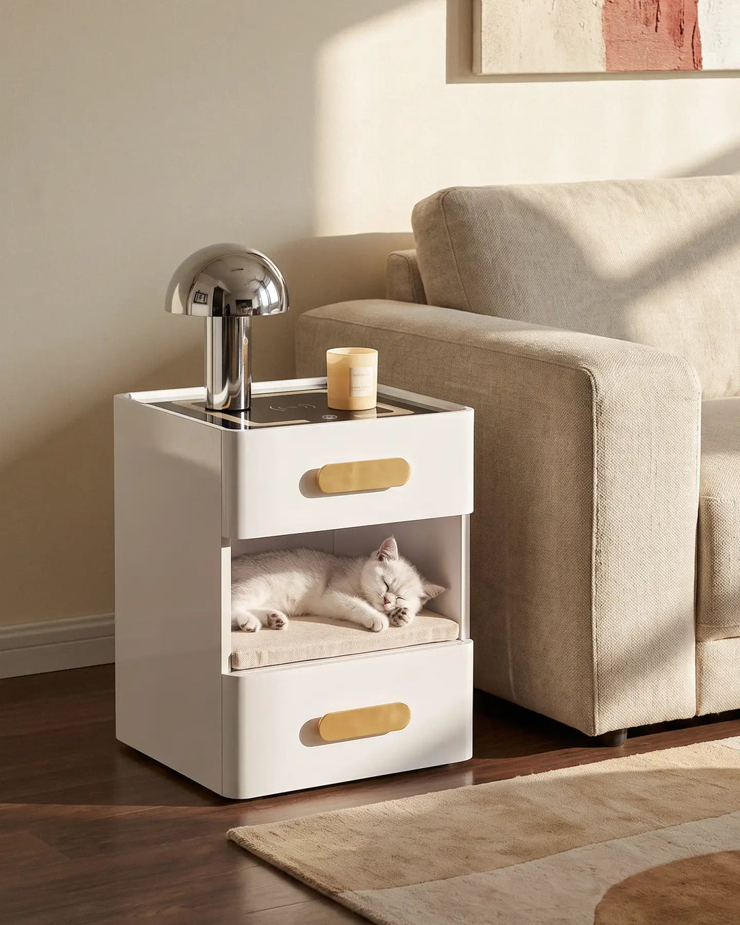 A white Clara LED bedside table with a cat sleeping comfortably in the open middle storage shelf.