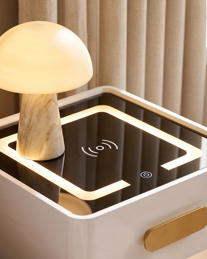 Close-up of the black tempered glass top of the Clara nightstand showing the wireless charging icon and touch controls.