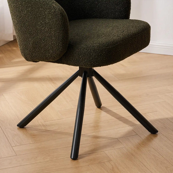 Close-up of the heavy-duty matte black metal spider swivel legs resting on parquet flooring, designed for smooth 360-degree rotation.