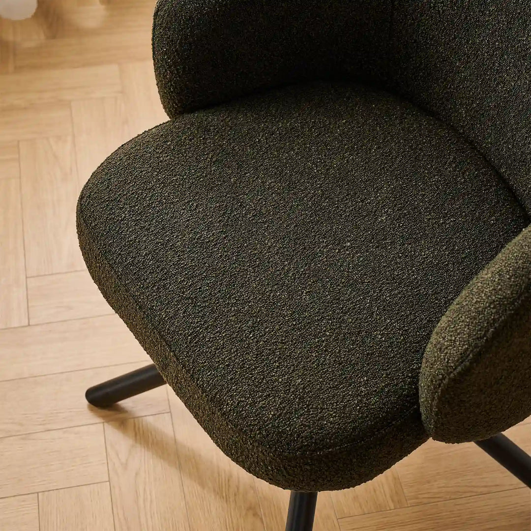 Top-down detail of the generous high-density foam seat cushion upholstered in hard-wearing textured green bouclé fabric.
