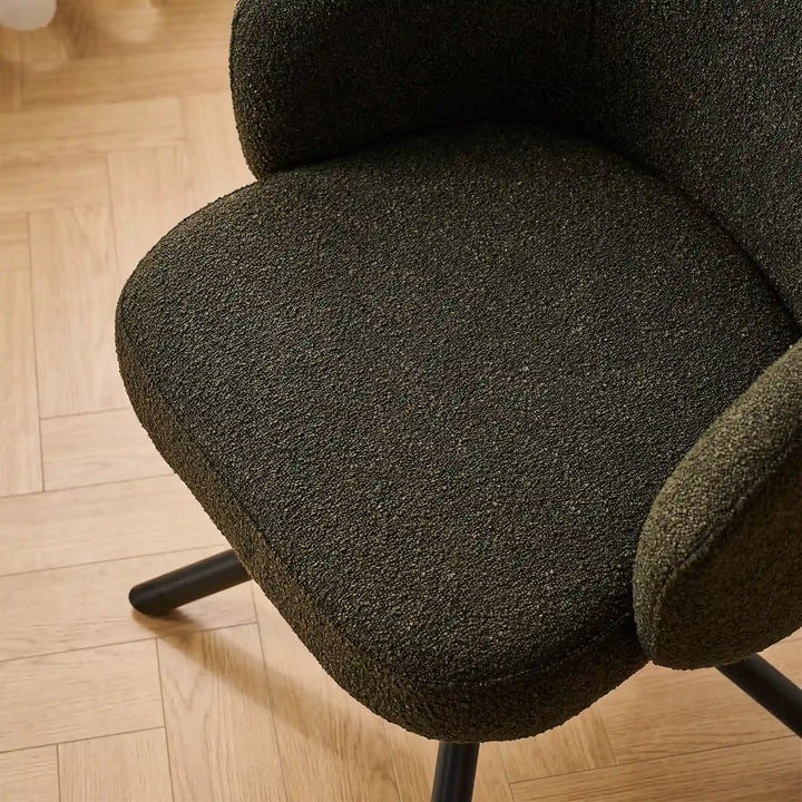 Top-down detail of the generous high-density foam seat cushion upholstered in hard-wearing textured green bouclé fabric.