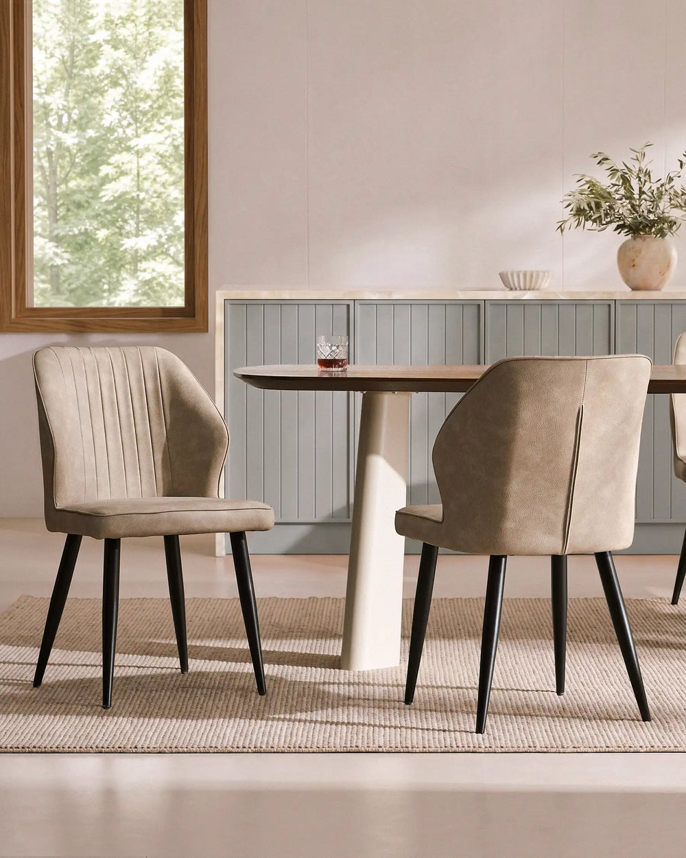 Beige Danforth faux leather dining chairs with Danforth dining table in a contemporary dining room, front view