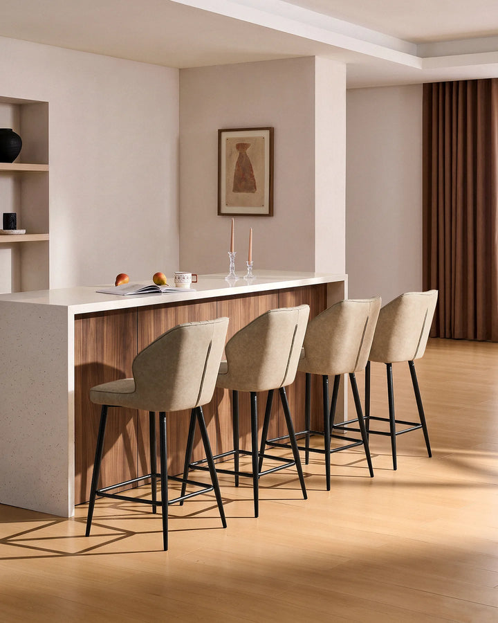 Danforth beige bar stools styled around a wood and white kitchen island in a warm modern interior with natural wood flooring