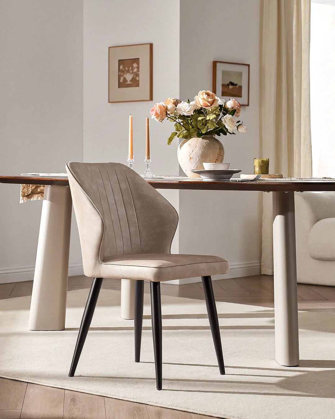 Contemporary Danforth dining chair with black tapered metal legs in a bright dining room setting.