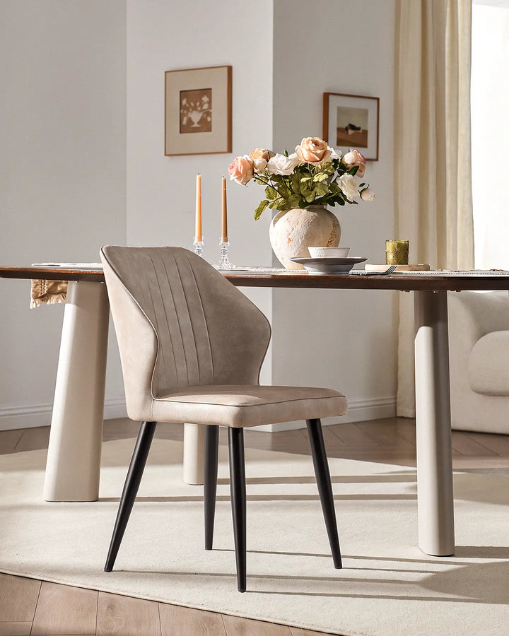 Contemporary Danforth dining chair with black tapered metal legs in a bright dining room setting.