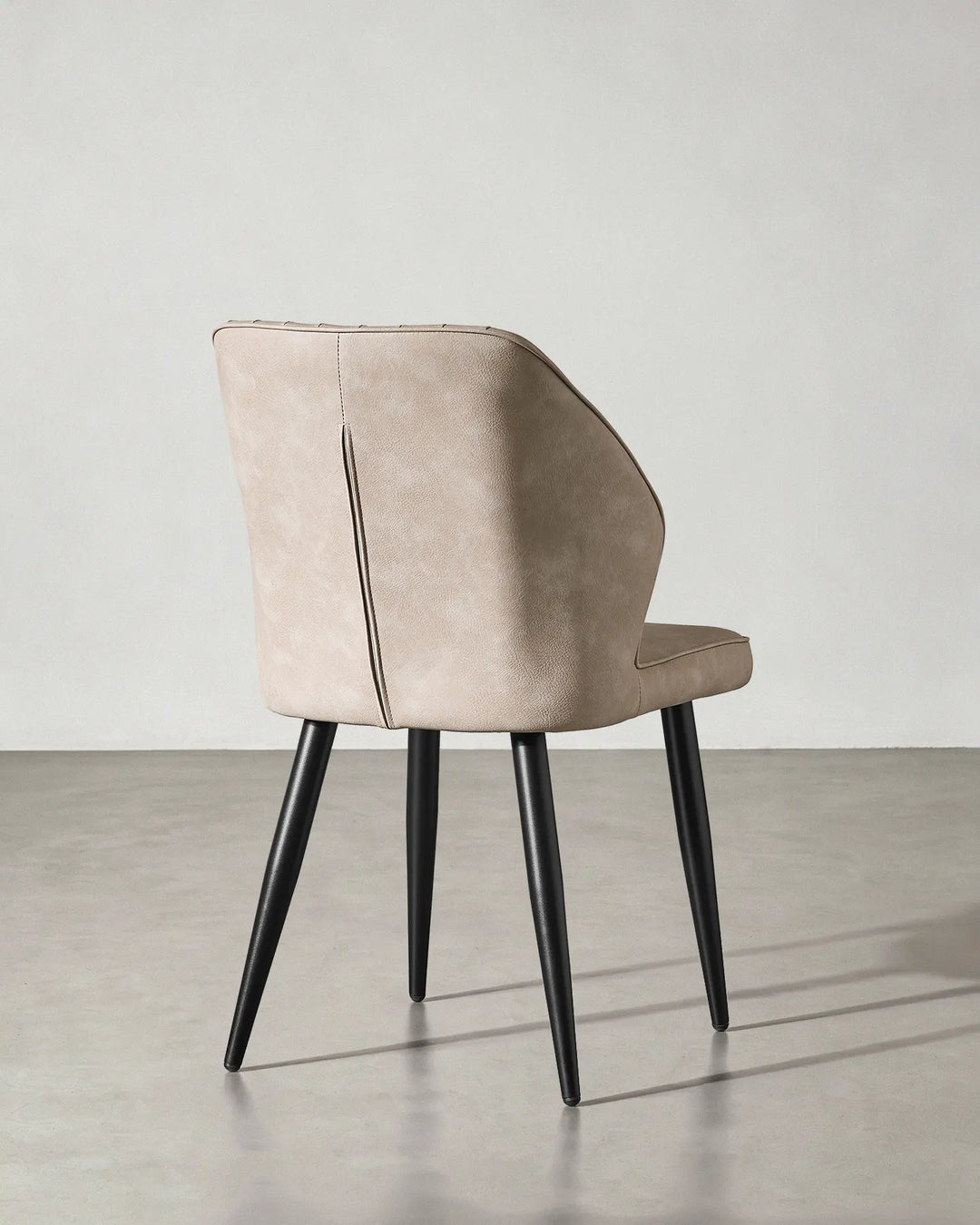 Rear view of the Danforth dining chair showcasing the clean finish of the upholstery.