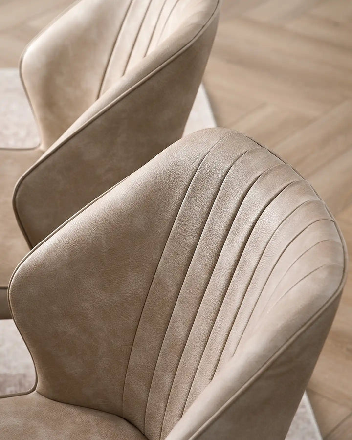 Close-up of the vertical fluted stitching on the Danforth beige faux leather backrest.