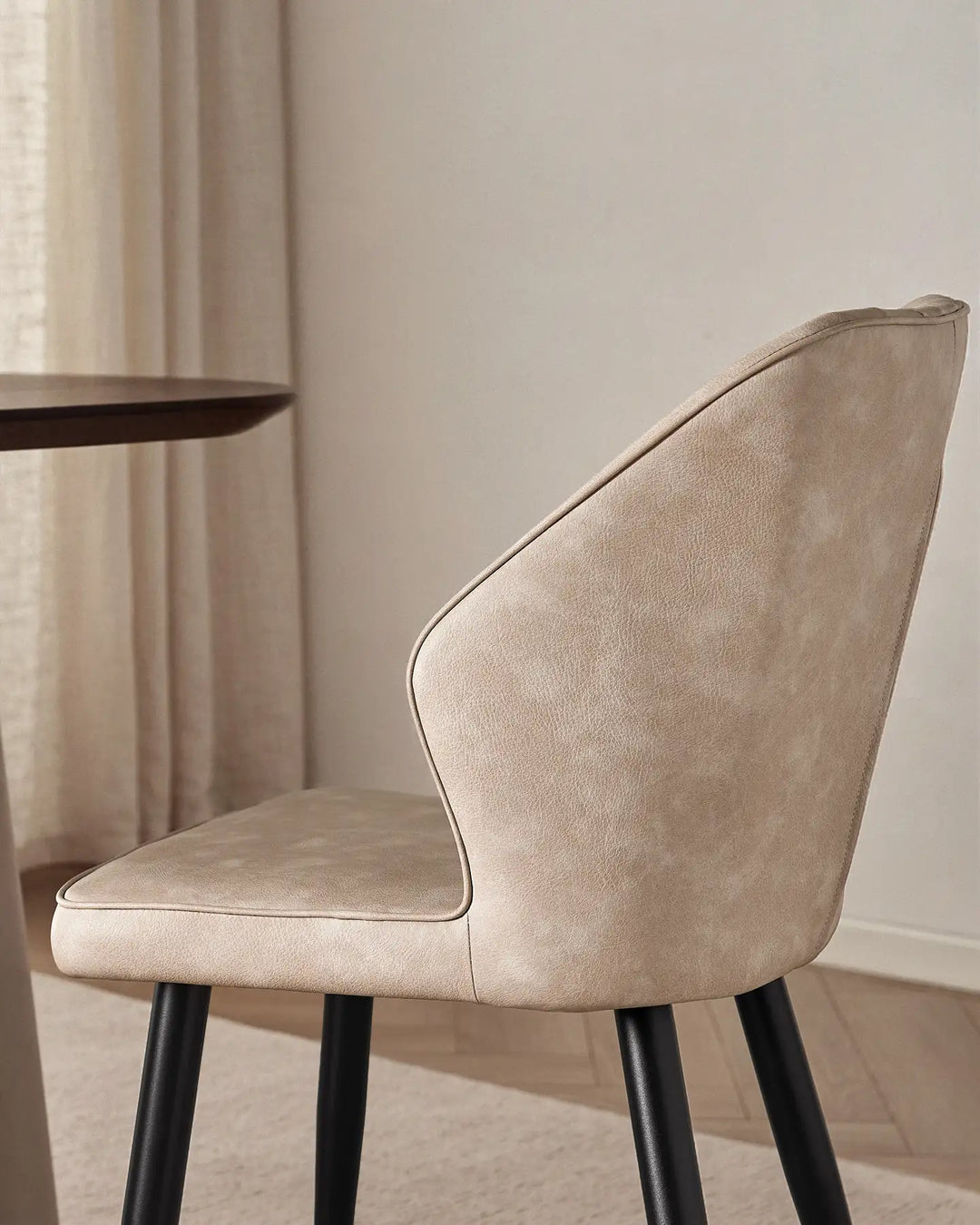 Close-up of the sleek winged side profile of the Danforth upholstered chair.