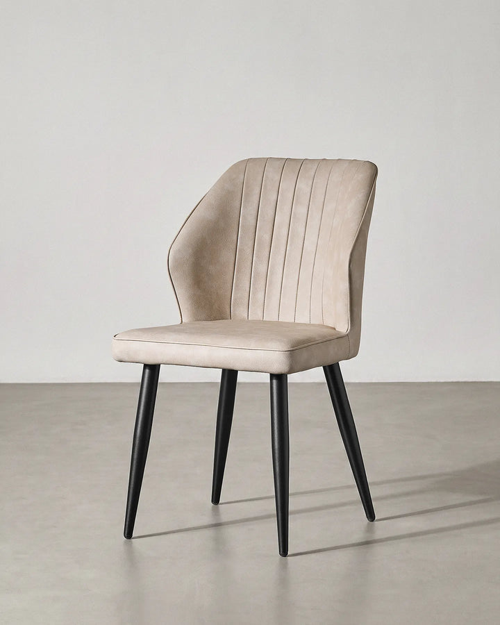  Studio shot of the Danforth beige dining chair at a 45-degree angle on a grey background.