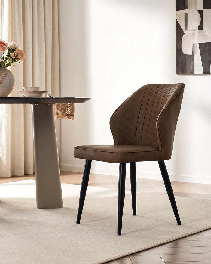 Danforth upholstered dining chair in brown featuring elegant vertical quilted stitching.