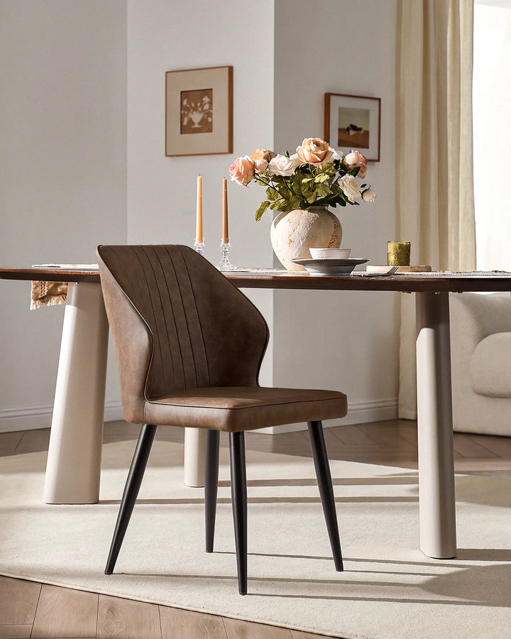 Contemporary Danforth dining chair with black tapered metal legs in a bright dining room setting.