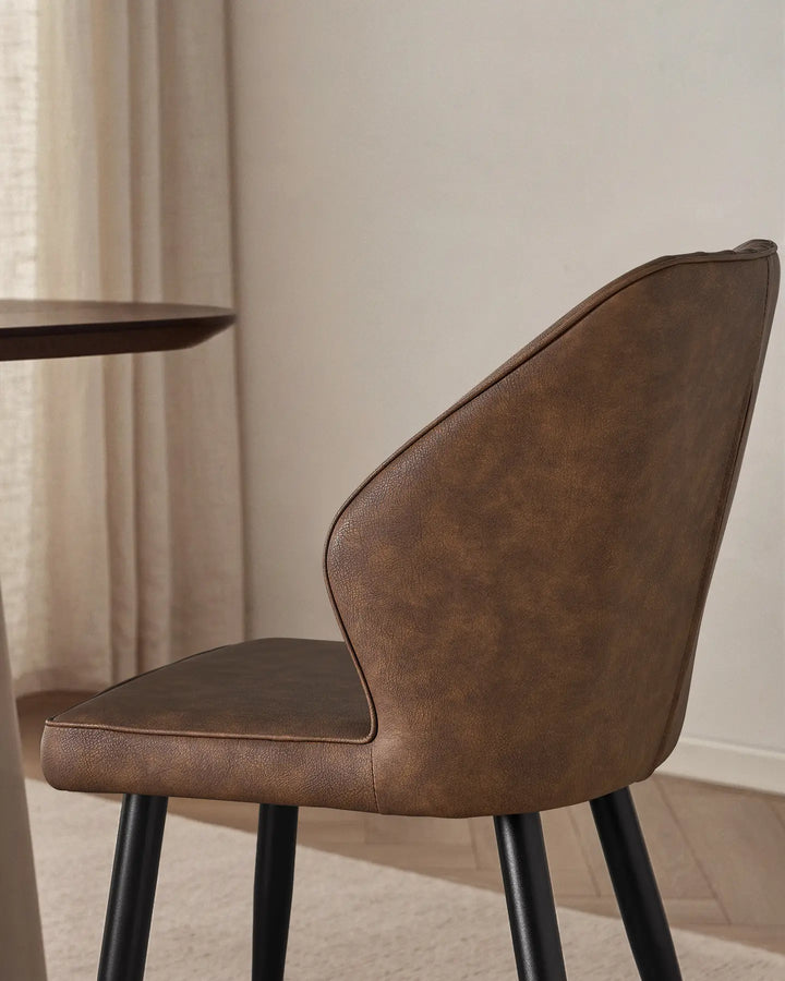 Close-up of the sleek winged side profile of the Danforth upholstered chair.