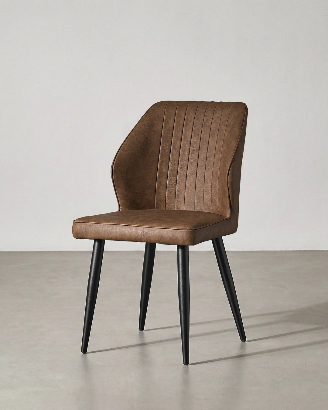 Studio shot of the Danforth brown dining chair at a 45-degree angle on a grey background.
