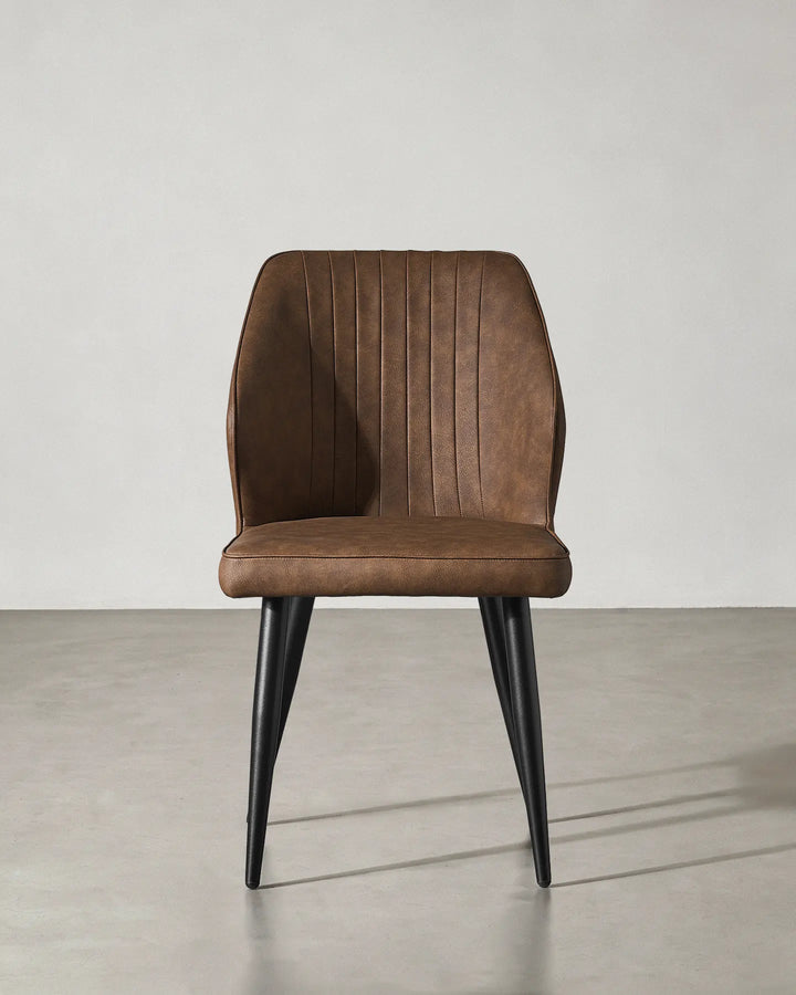 Front view of the Danforth faux leather chair highlighting its symmetrical contemporary design.
