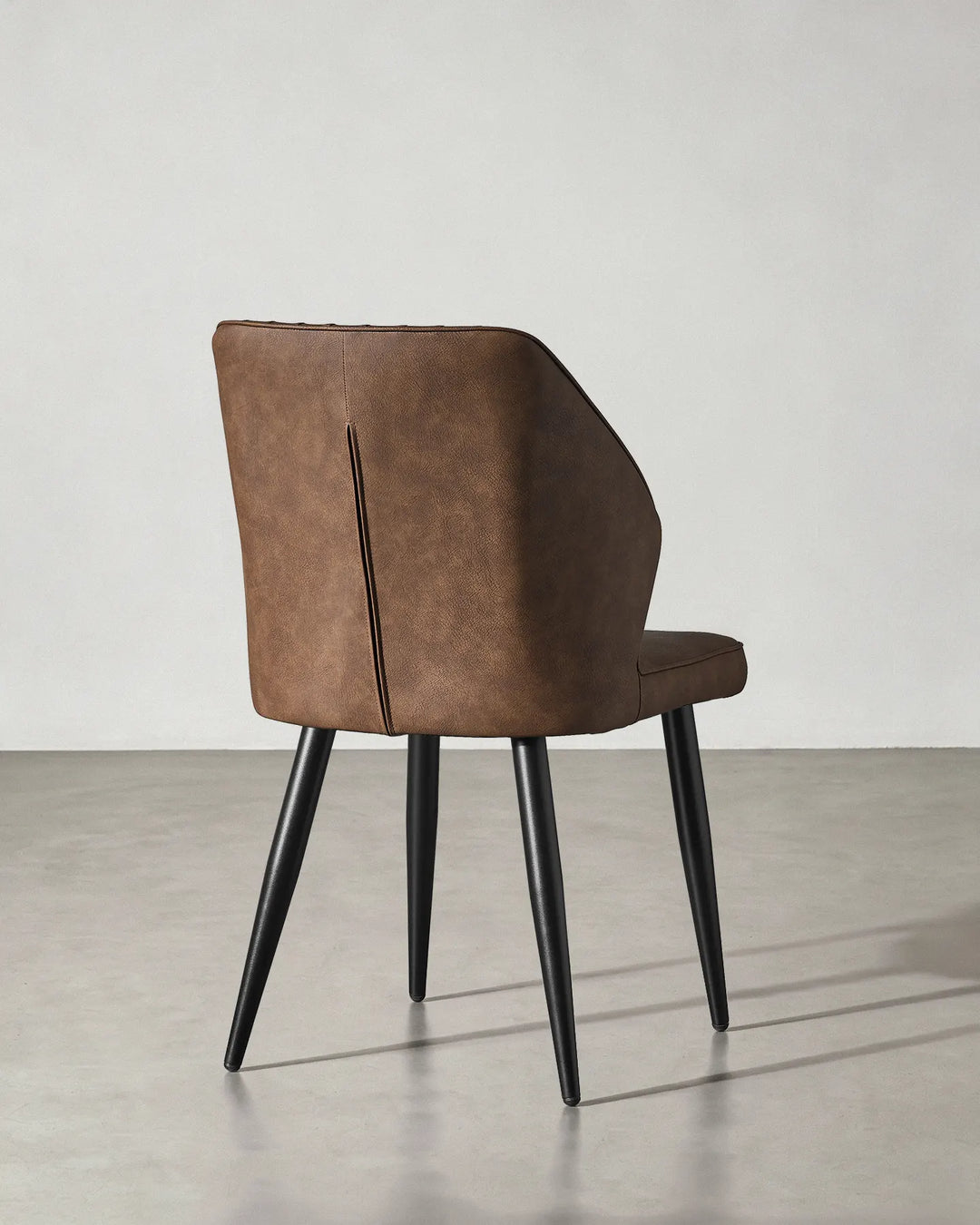 Rear view of the Danforth dining chair showcasing the clean finish of the upholstery.