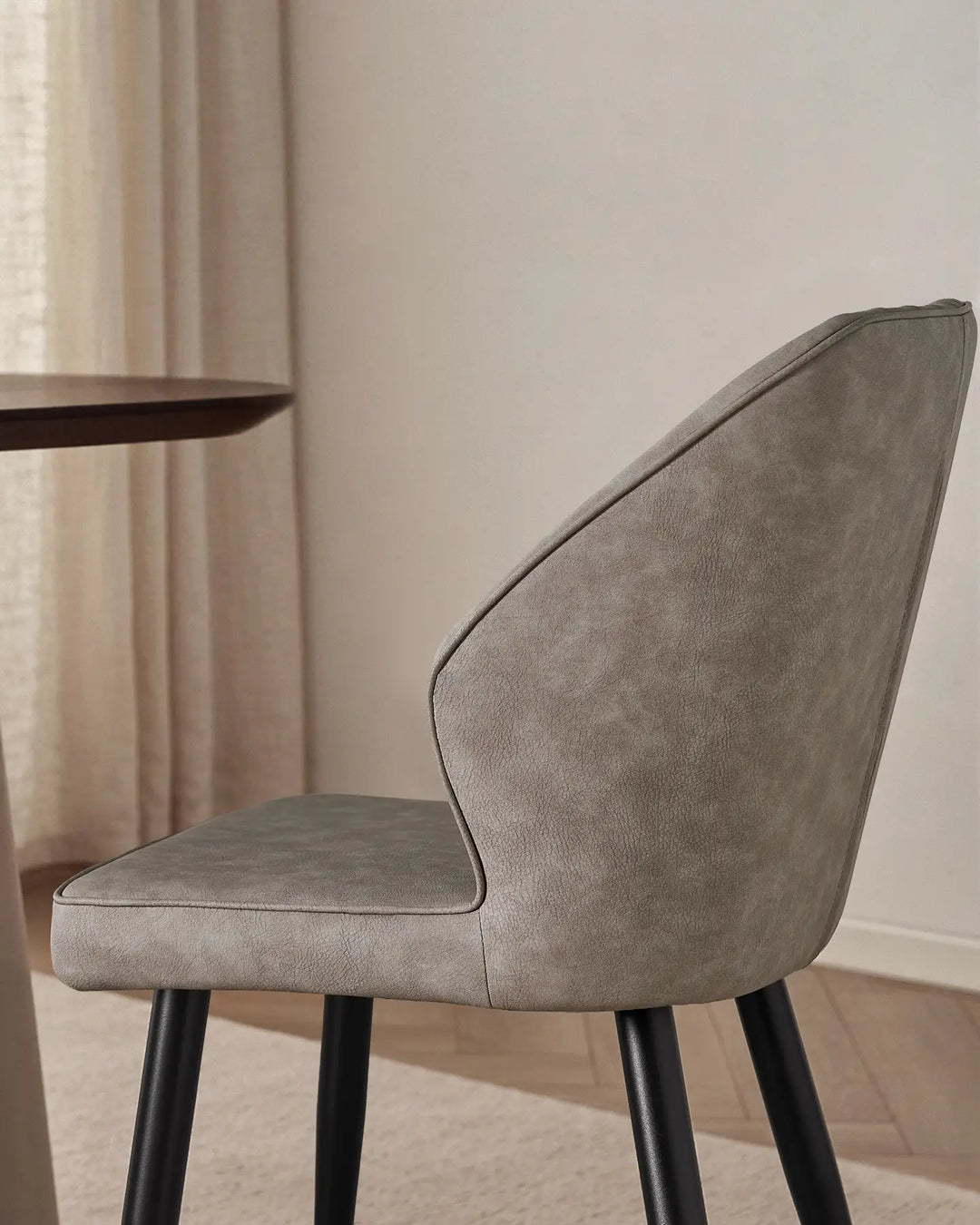 Close-up of the sleek winged side profile of the Danforth upholstered chair.