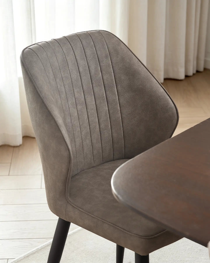 Close-up of the vertical fluted stitching on the Danforth light grey faux leather backrest.