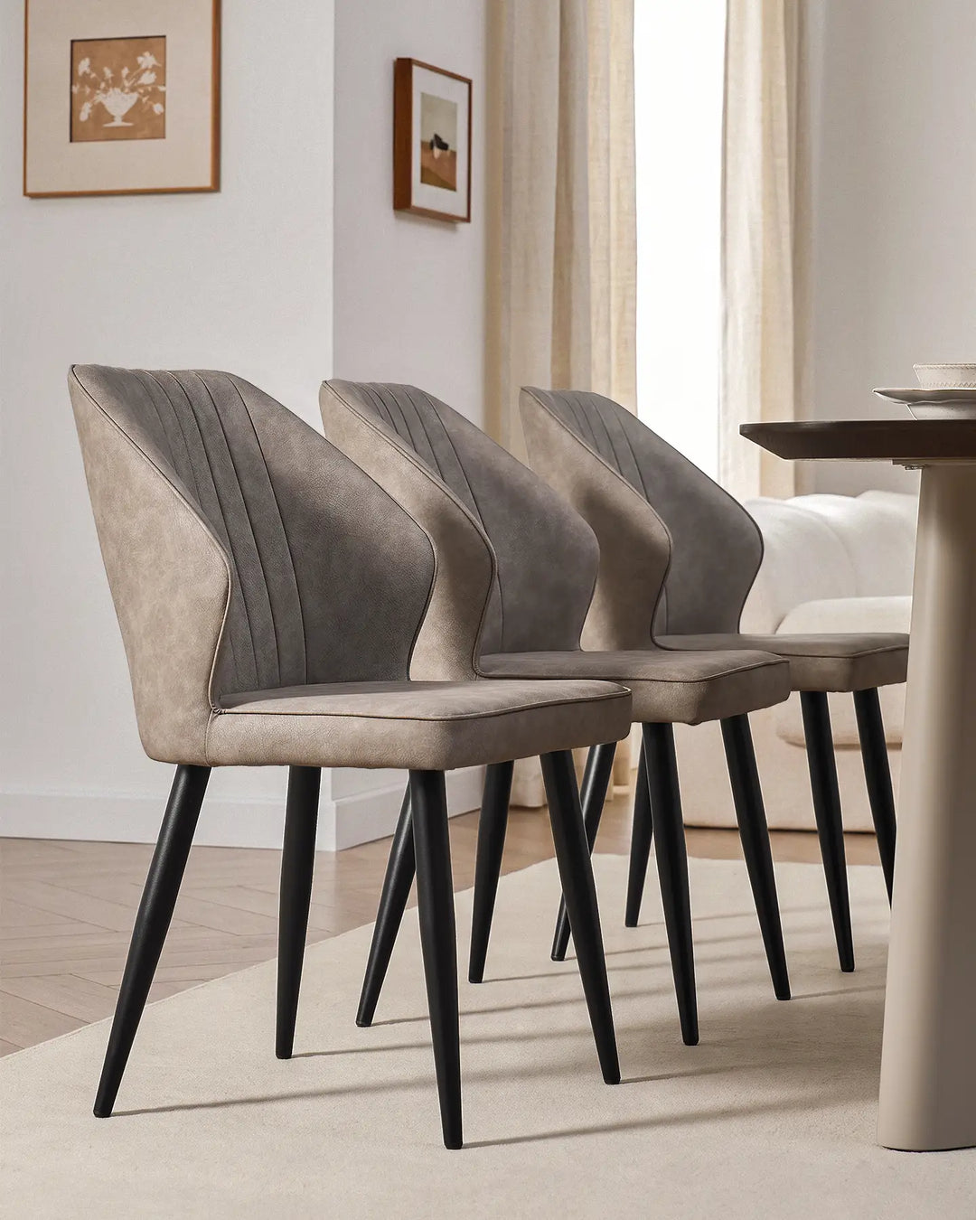 Side-by-side view of three Danforth faux leather chairs showcasing their slim, modern profile.