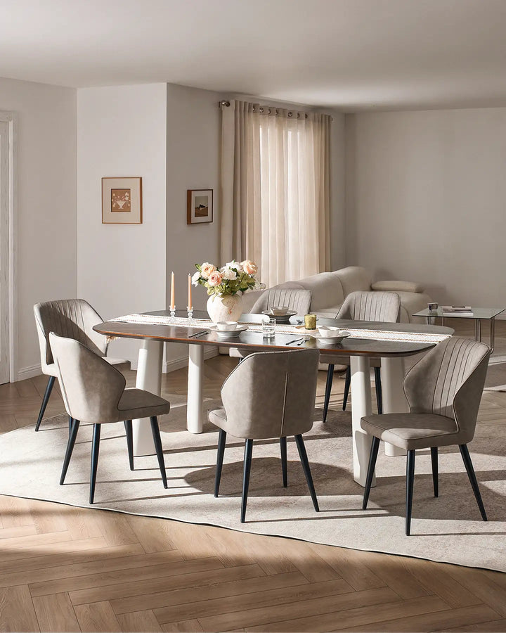 Full dining set view showing multiple Danforth light grey chairs around a large rectangular table.