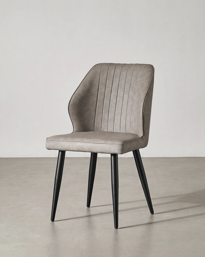 Studio shot of the Danforth light grey dining chair at a 45-degree angle on a grey background.