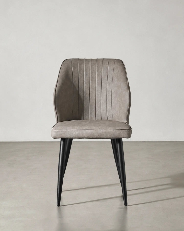 Front view of the Danforth faux leather chair highlighting its symmetrical contemporary design.