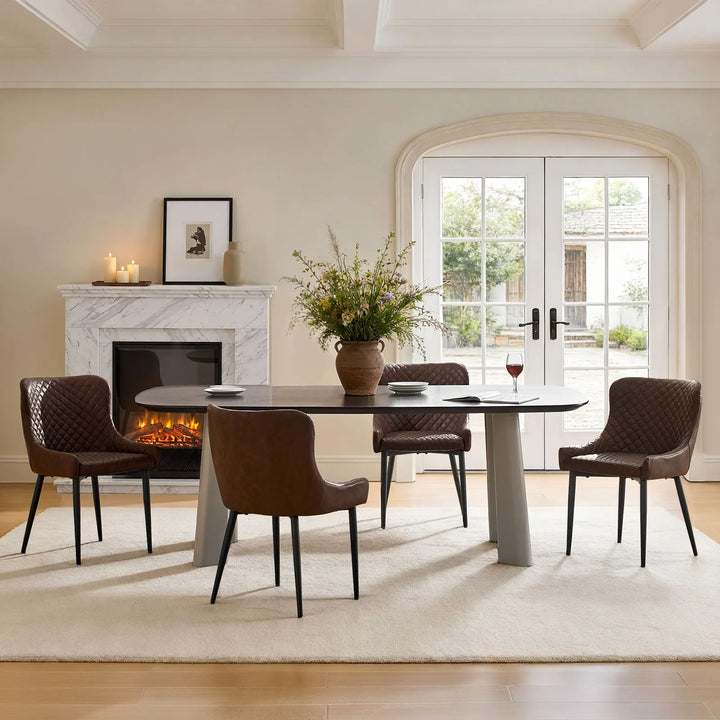 Set of four brown faux leather dining chairs beside a dining table in a contemporary dining interior