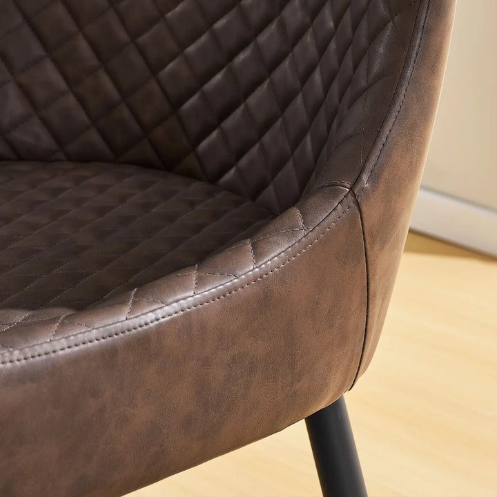 Detailed stitching on the armrest of the brown faux leather dining chair with neat and precise finish