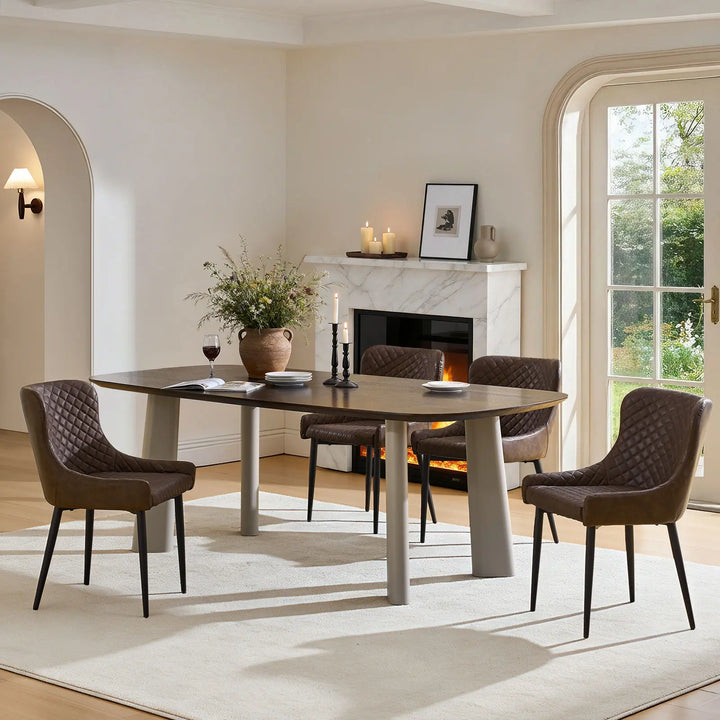 Four brown faux leather dining chairs arranged around a dining table in a modern dining room