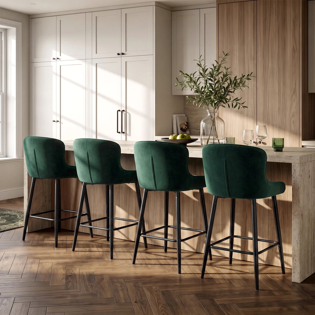Four Dundas green velvet bar stools arranged around a modern kitchen island in a contemporary home