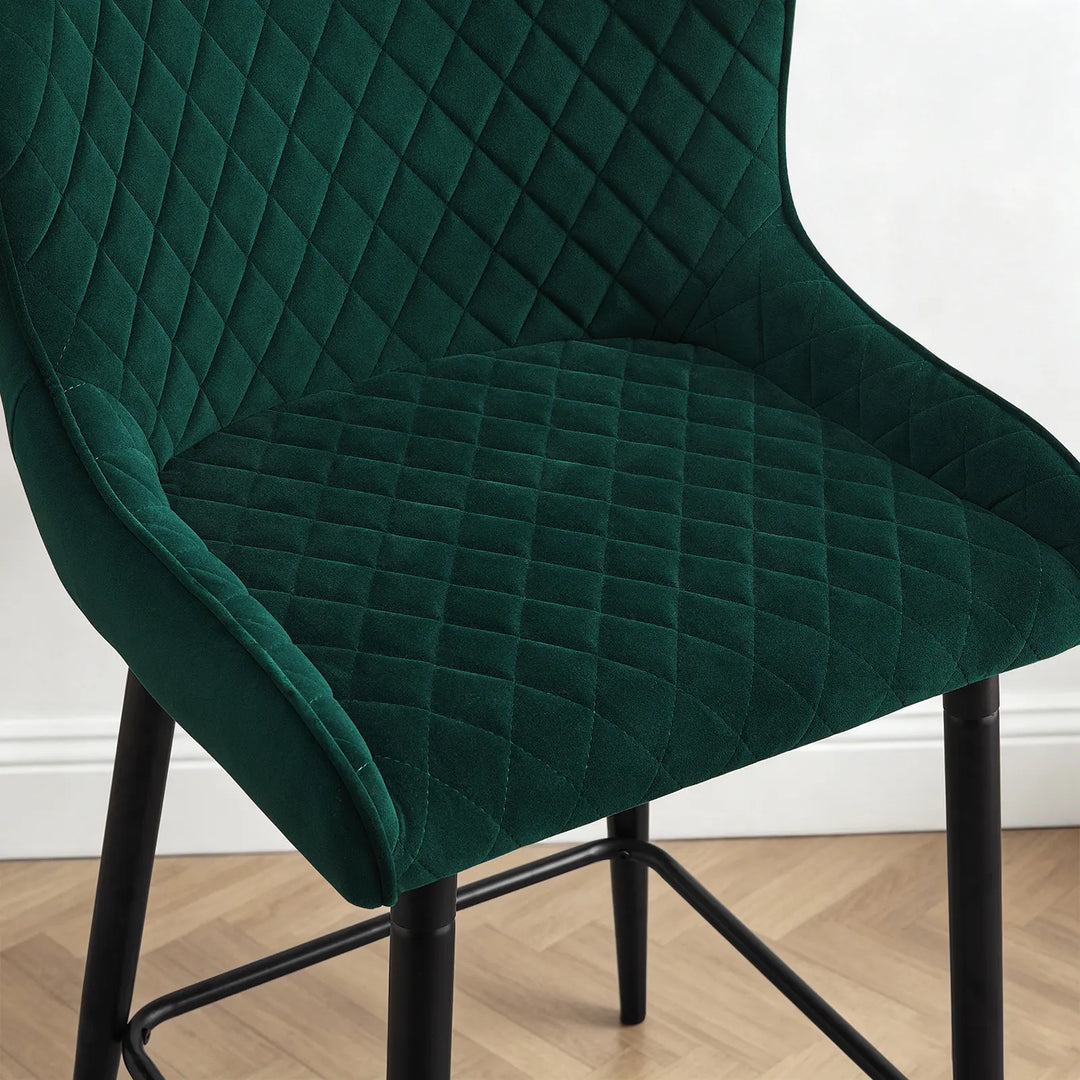 Close-up of Dundas bar stool showing the soft green velvet upholstery and diamond quilted detailing