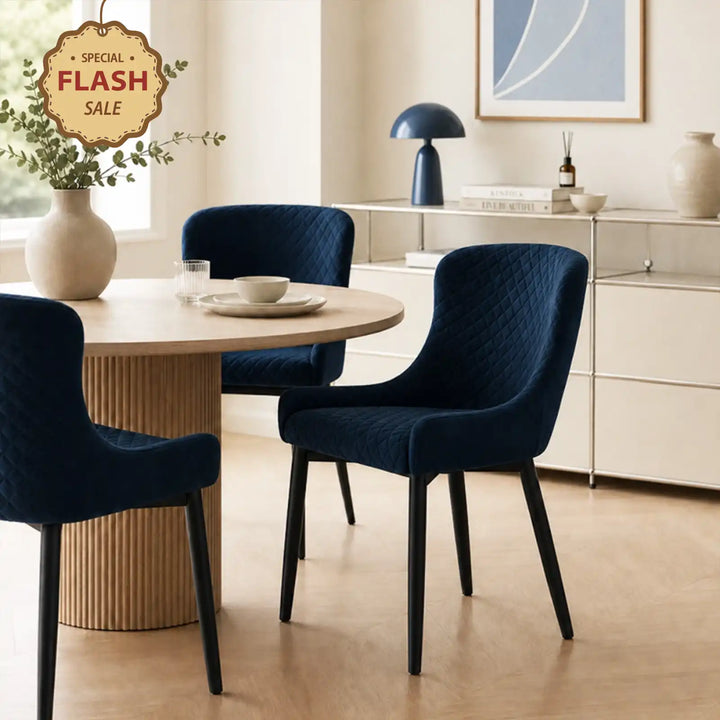 Dundas Velvet Dining Chairs with black metal legs in a bright dining area