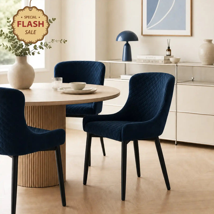 Dundas Velvet Dining Chairs with black metal legs in a bright dining area