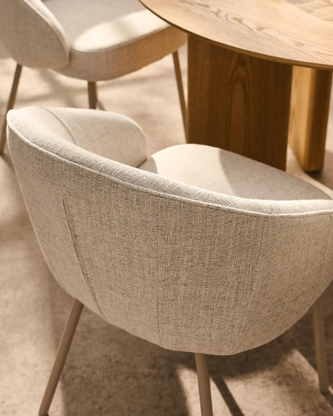 Detail of the Elowen beige linen dining chair featuring a generously padded curved backrest for lasting comfort and support